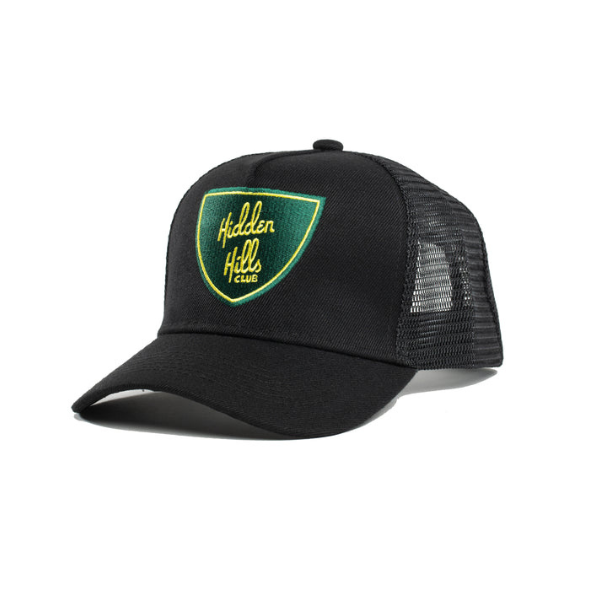 The Mystery Swag cap by Everyday Delta is a top-notch black mesh hat with a curved brim, adorned with a green and yellow "Hidden Hills Club" patch on the front. It's an essential accessory for brand enthusiasts.