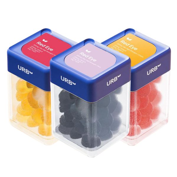 Three clear containers with blue lids labeled "Urb Red Eye Skybites Gummies" hold yellow, black, and red gummy candies. Each container has a label on top with product information and mentions Delta-8.