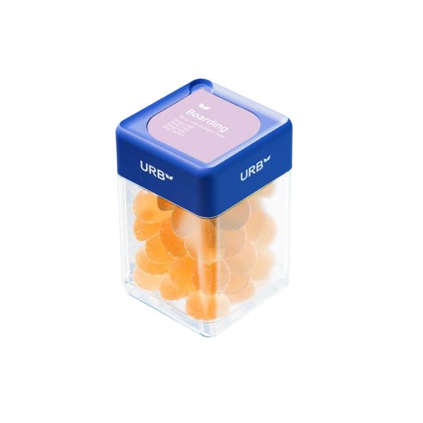 A plastic container with a blue lid, labeled "Urb Boarding Skybites Delta 9 Gummies." The container is filled with orange circular gummies infused with Delta 9 THC.