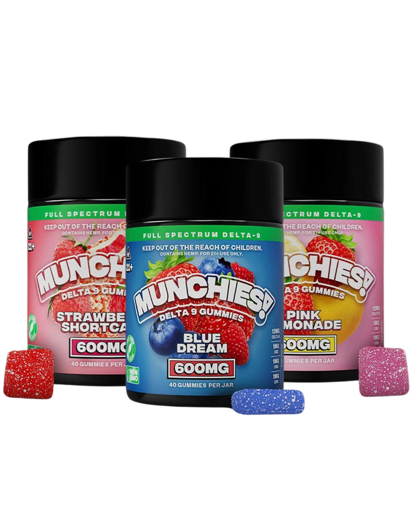 Three jars of Delta Munchies Delta 9 Gummies in flavors Strawberry Shortcake, Blue Dream, and Pink Lemonade, each labeled with 600mg of Delta 9 THC. Two gummy pieces are shown in front of each jar. Enjoy the natural cannabinoids delivered by these full spectrum gummies for an enhanced experience.