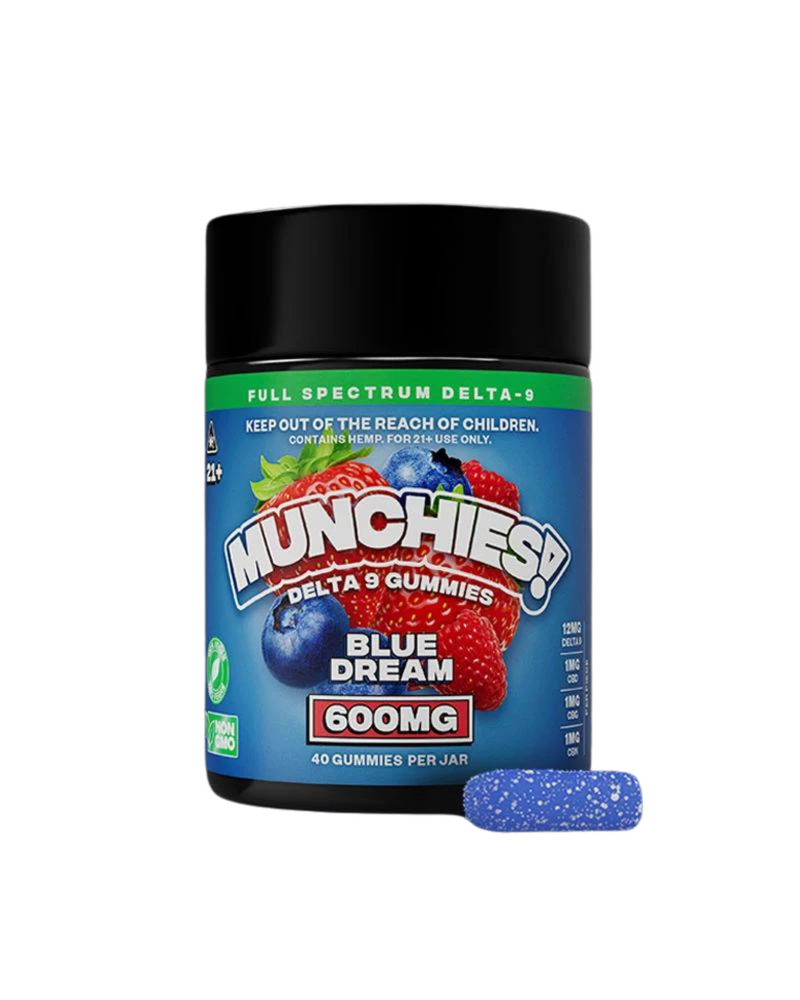 A container labeled "Delta Munchies! Delta 9 Gummies Blue Dream 600mg" with images of fruits, next to a single blue gummy candy. The container, featuring full spectrum gummies, warns to keep out of children's reach and contains 40 gummies.