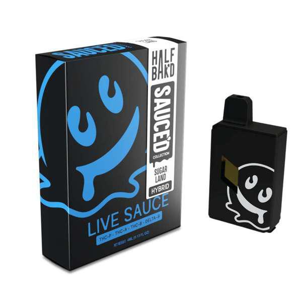 A black box labeled "Half Bak'd" Half Bak'd Live Resin Sauced Disposable | 4g. Next to the box is a black disposable vape device with a white smiley face design matching the one on the box. The device features THC-A live resin from the Half Bak'd Live Resin Sauced Collection.