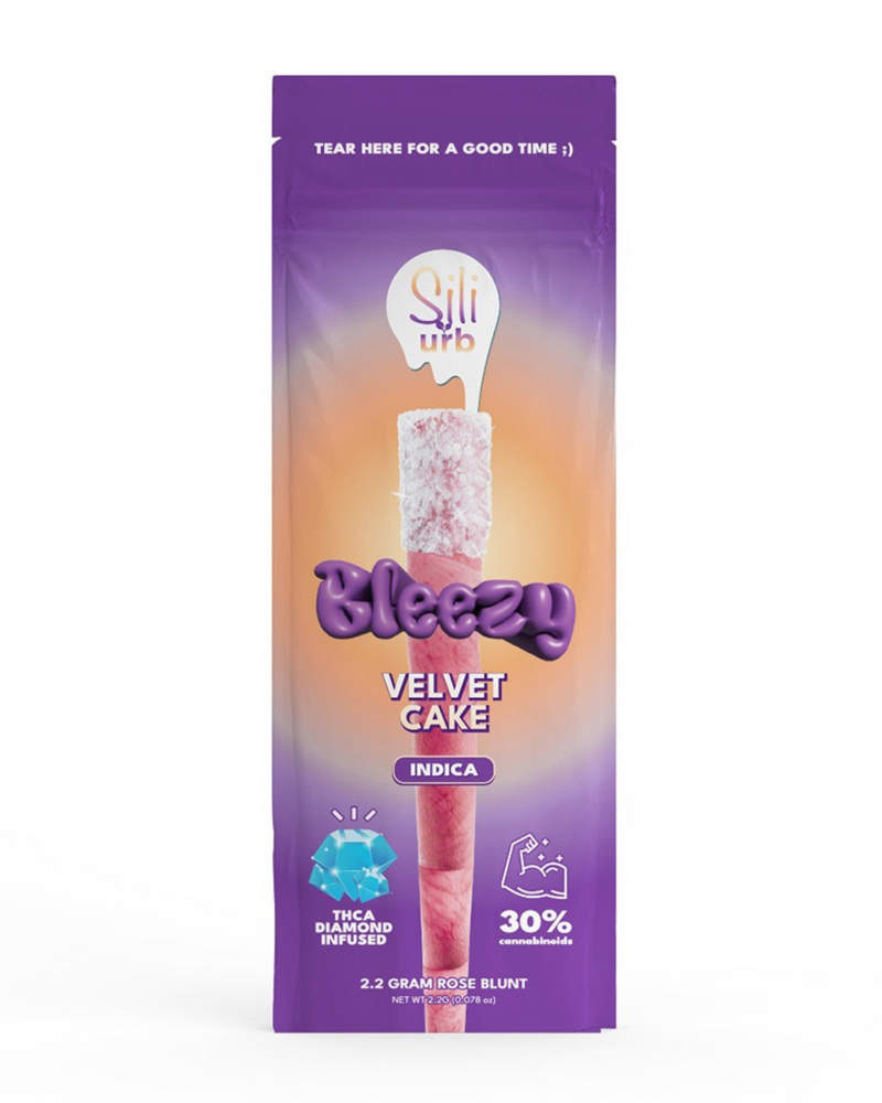 A purple and orange package of the "Sili x Urb Bleezy THCA Snow Capped Preroll" features an indica pre-roll infused with THCA Liquid Diamonds. Offering 2.2 grams, this product from Urb boasts a rich blend with 30% cannabinoids.