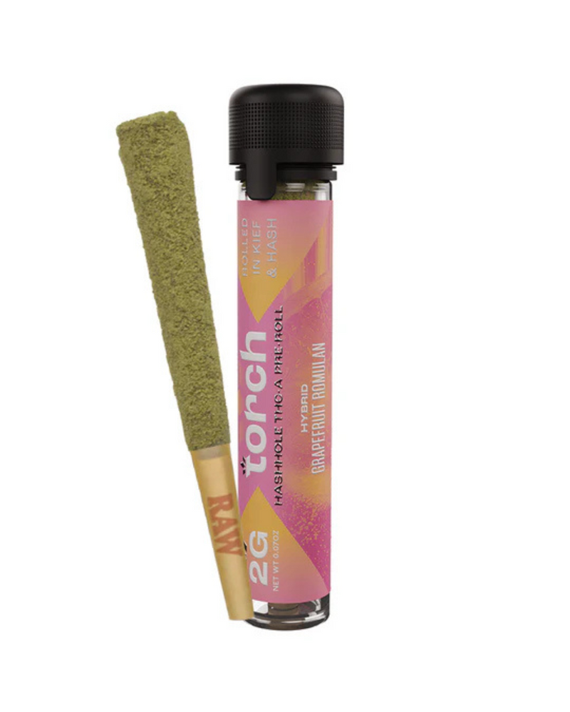 A premium Torch Hashhole THCA Pre-Roll, hand-dipped in hash and coated in kief, rests beside a transparent tube labeled "Torch Hybrid Grapefruit Romulan.