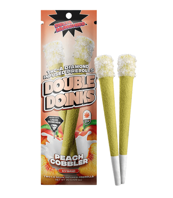 A package of Delta Munchies THC-A Diamond Infused Prerolls | 2pk, Peach Cobbler flavor, featuring two hybrid pre-rolls. The package showcases an image of the pre-rolls and is labeled with cannabis and age restriction symbols.