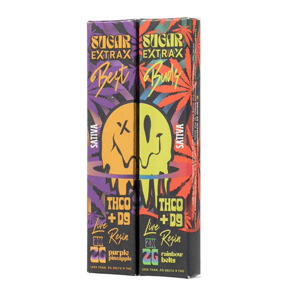 Two colorful boxes of Sugar Extrax Best Buds Disposable Vape 2 Pack labeled "Betty" and "Booty." Each contains 2 grams of live resin, with THC0+D9 formulations and flavors "Purple Pineapple" and "Rainbow Belts," now available in a convenient disposable vape.